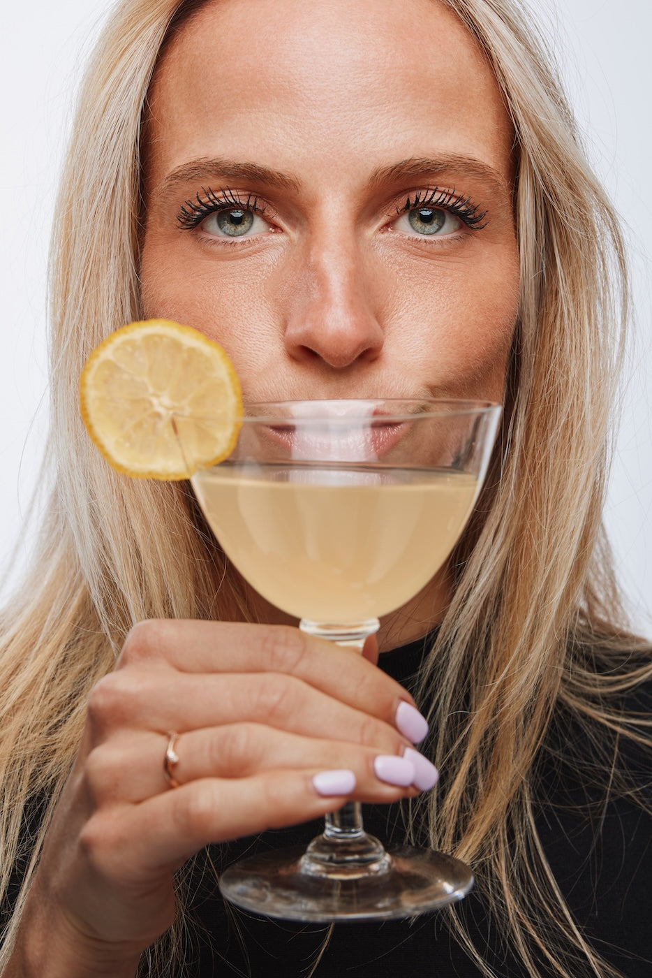 Woman enjoying GIGA sparkling collagen drink